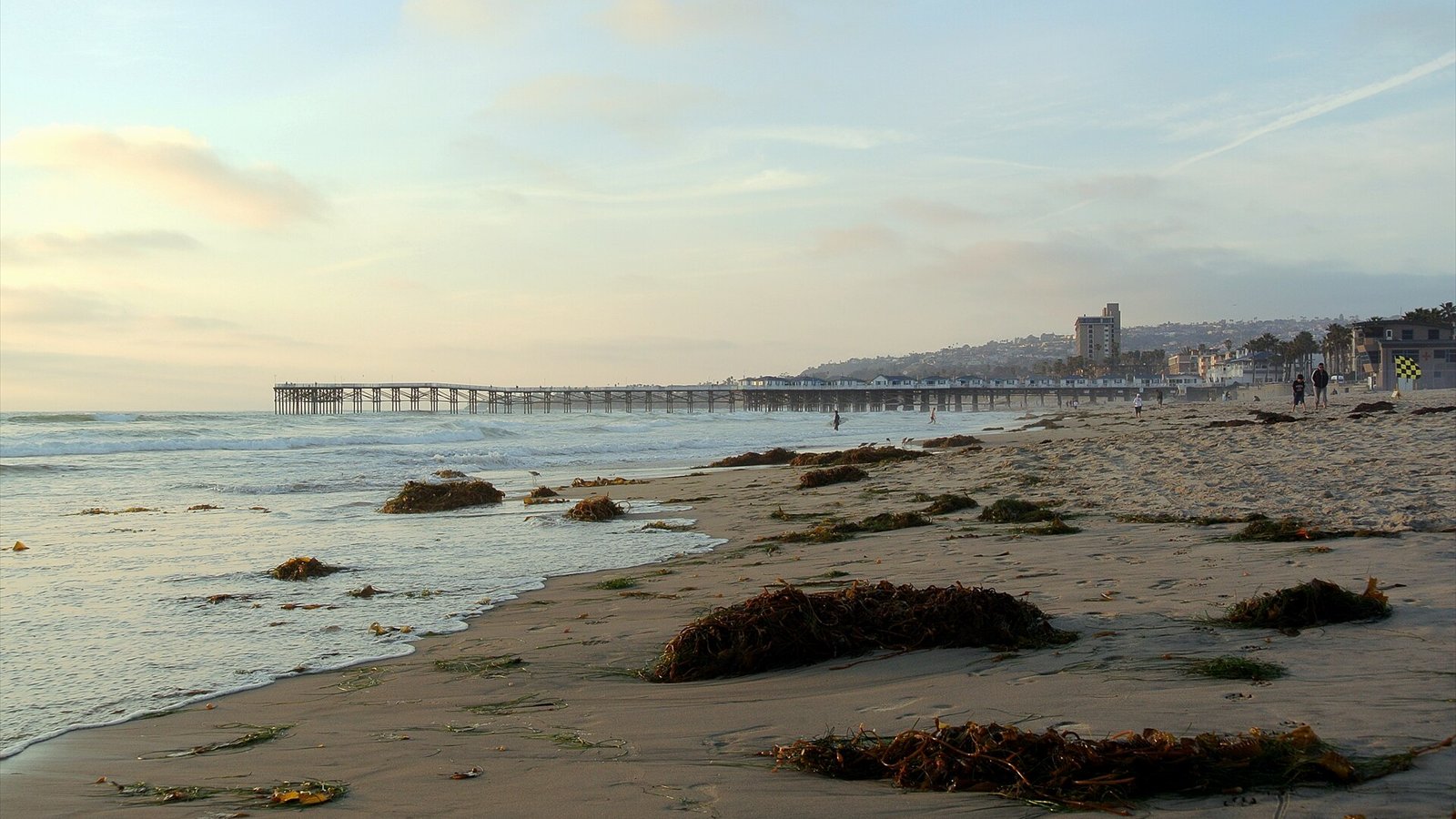 On Pacific Beach, San Diego, California, looking northwards, Crystal Pier is visible in the mid-distance, the southern part of La Jolla is visible in the far distance