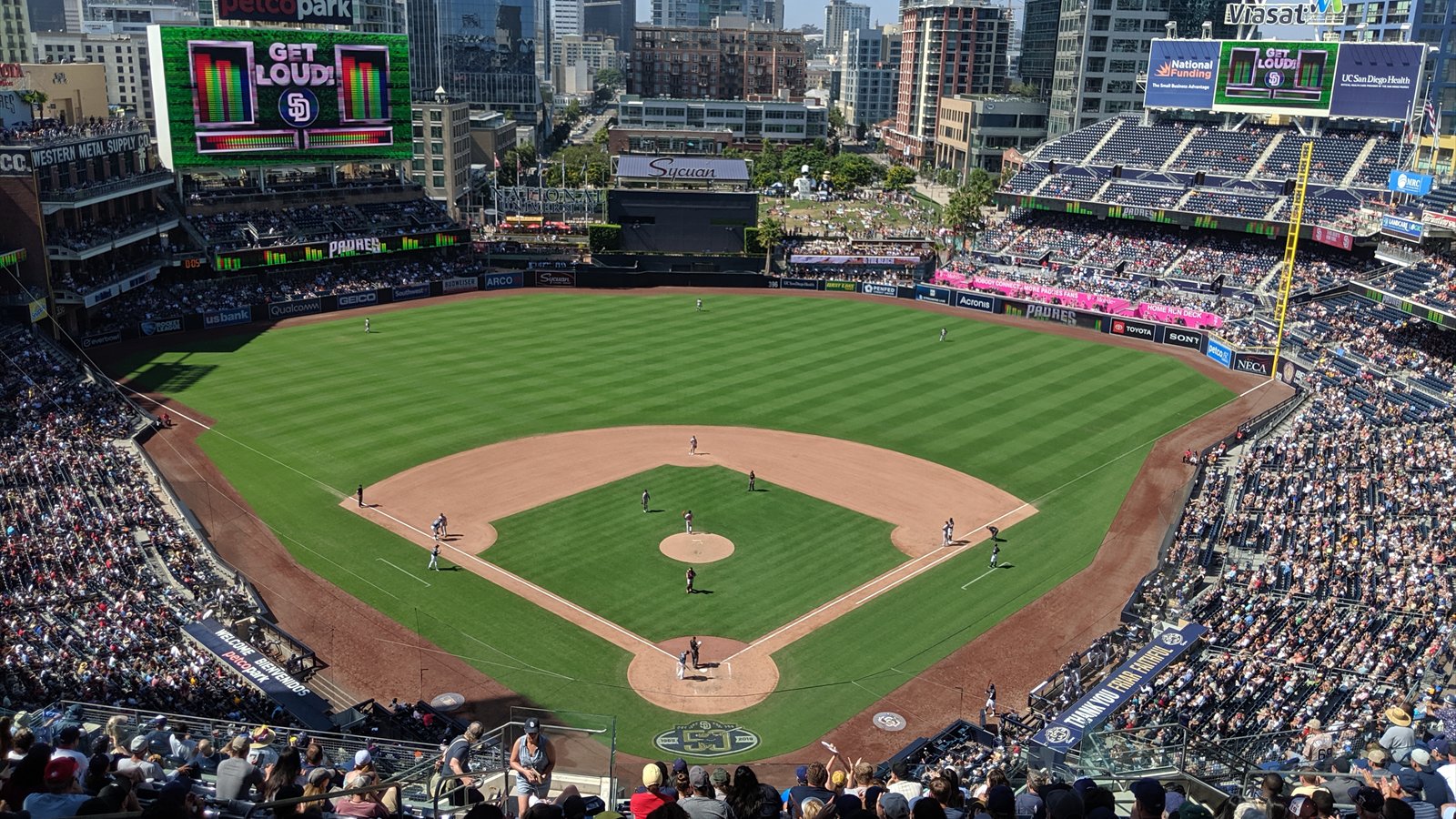 The San Diego Padres play a baseball game at Petco Park as spectators watch from the stands.