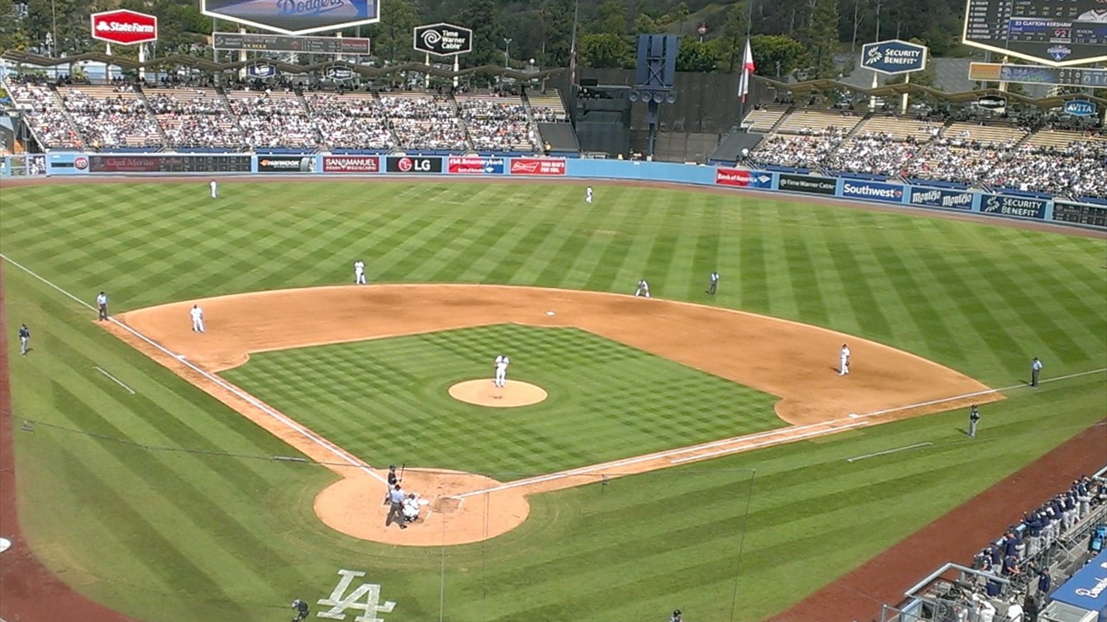 The Dodger Stadium baseball field is viewed from high in the upper deck beneath a pale sky.