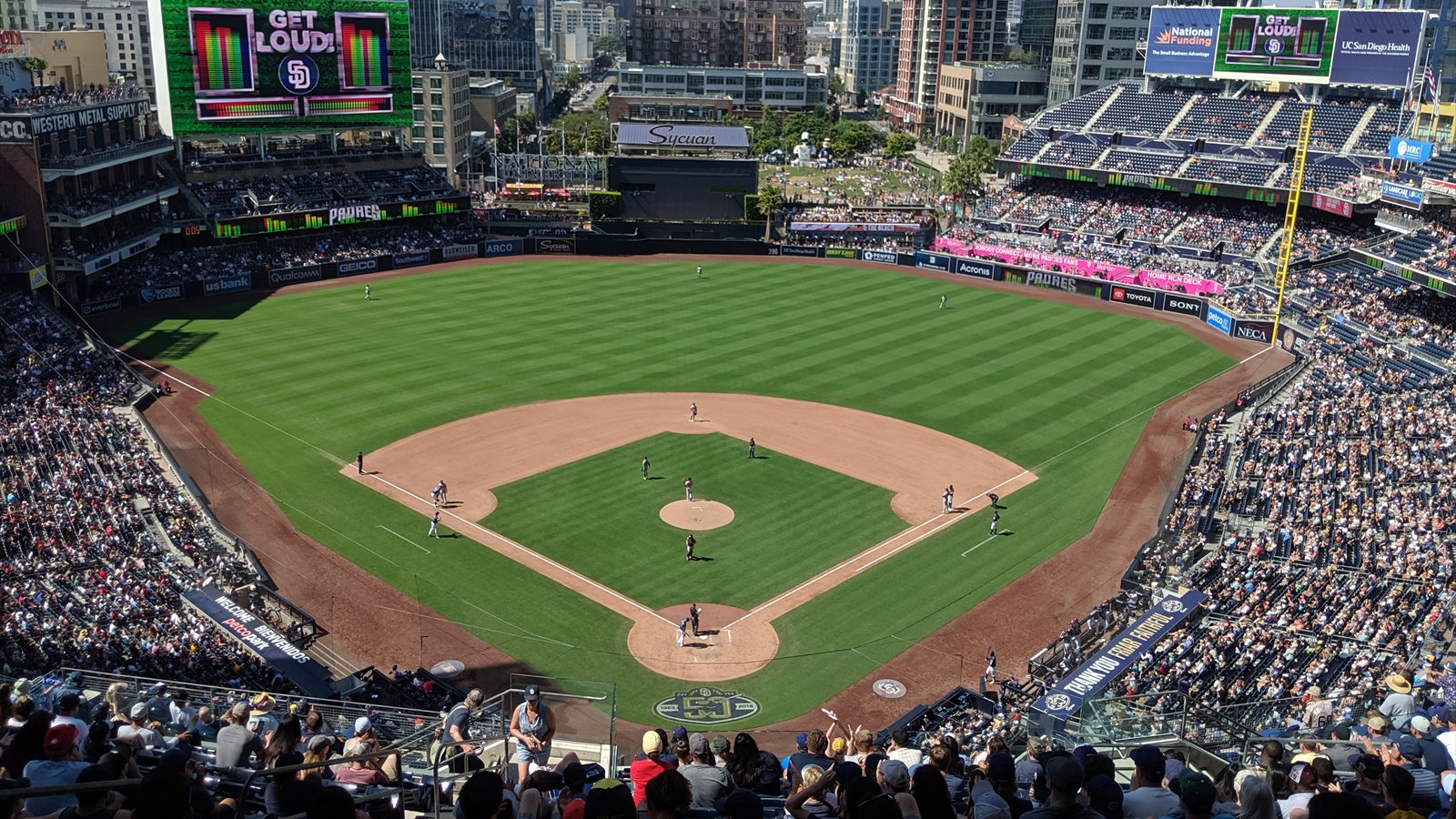 San Diego Padres players on the field during a day game at Petco Park.