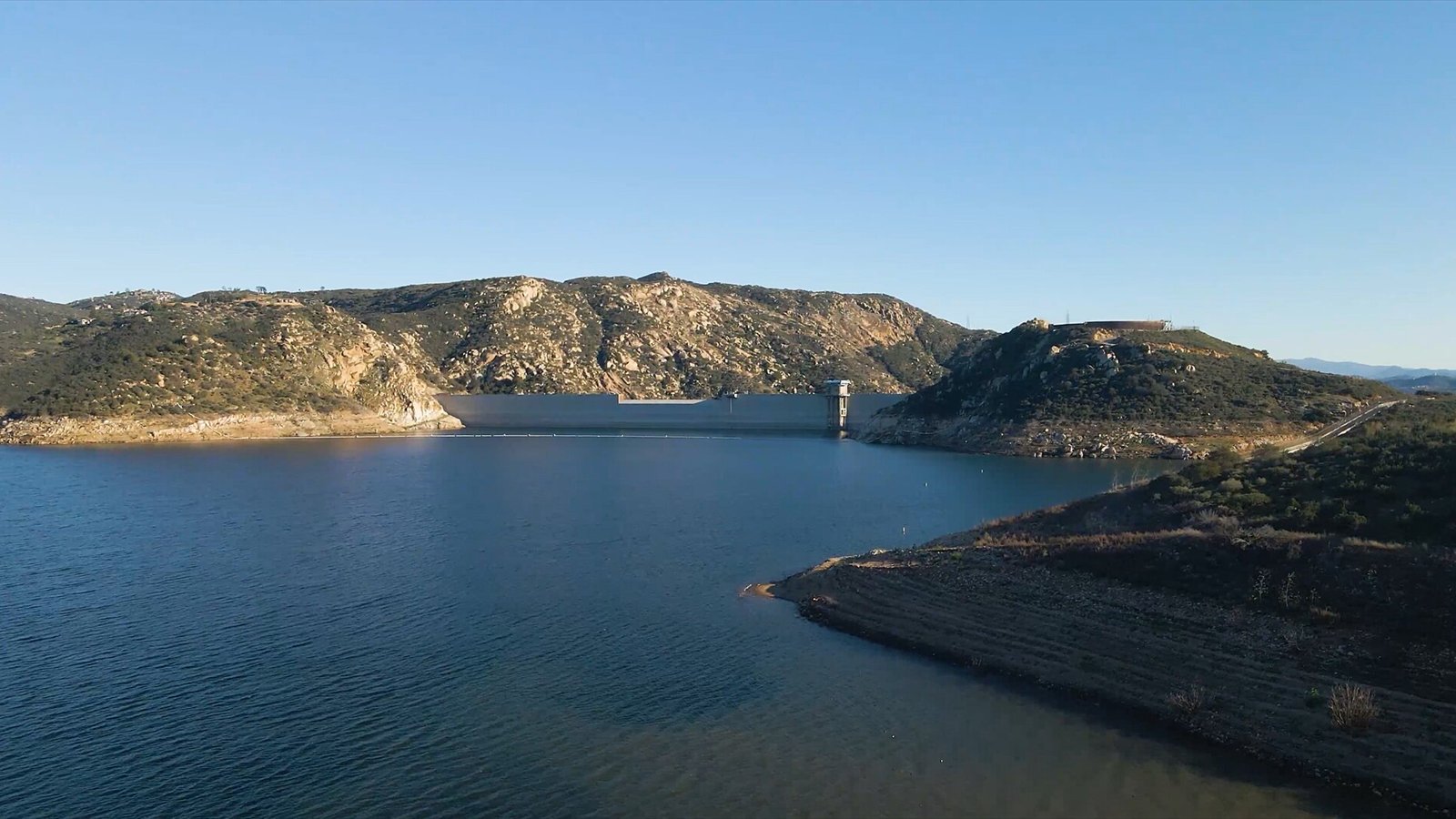 Aerial drone photography of San Vicente Reservoir and Dam located in the Cuyamaca Mountains of San Diego County photographed by Daniel Travers of Redideo Studio .