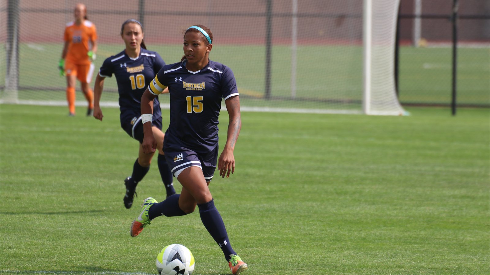 A University of Northern Colorado women's soccer player dribbles the ball during a match.
