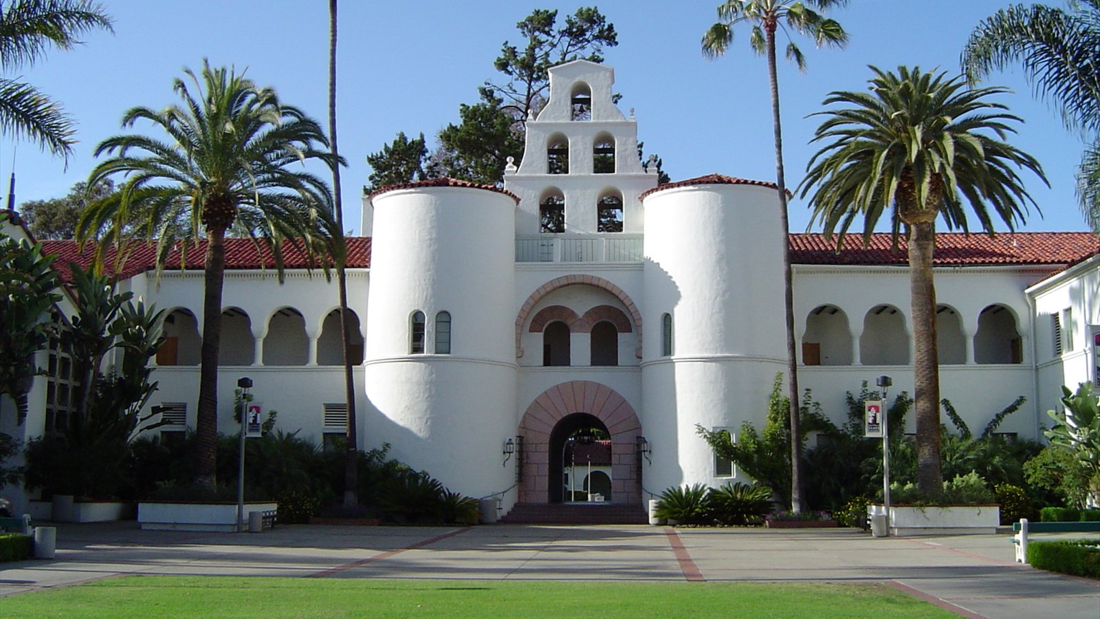 Mission Revival-style buildings line a paved courtyard on the San Diego State University campus.